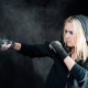 Blond boxing woman in black punching bag